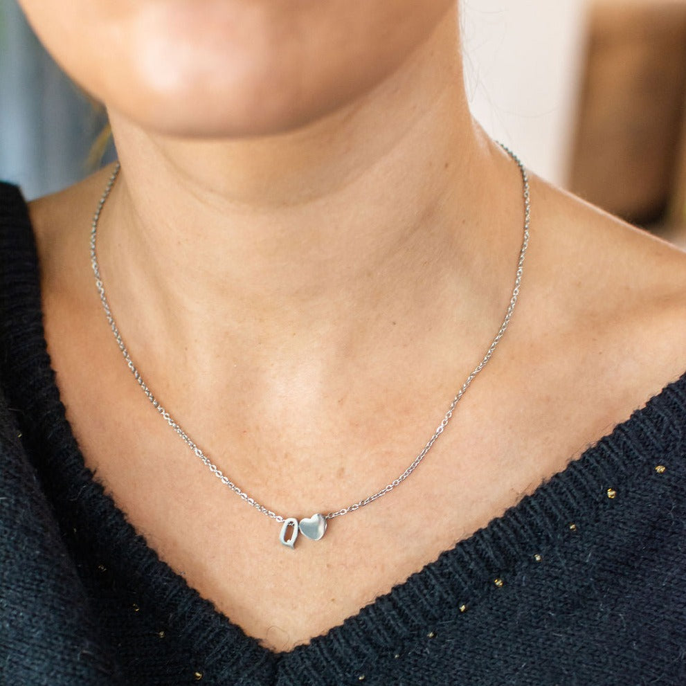 Stainless steel silver minimalist monogram and heart charm necklace.
