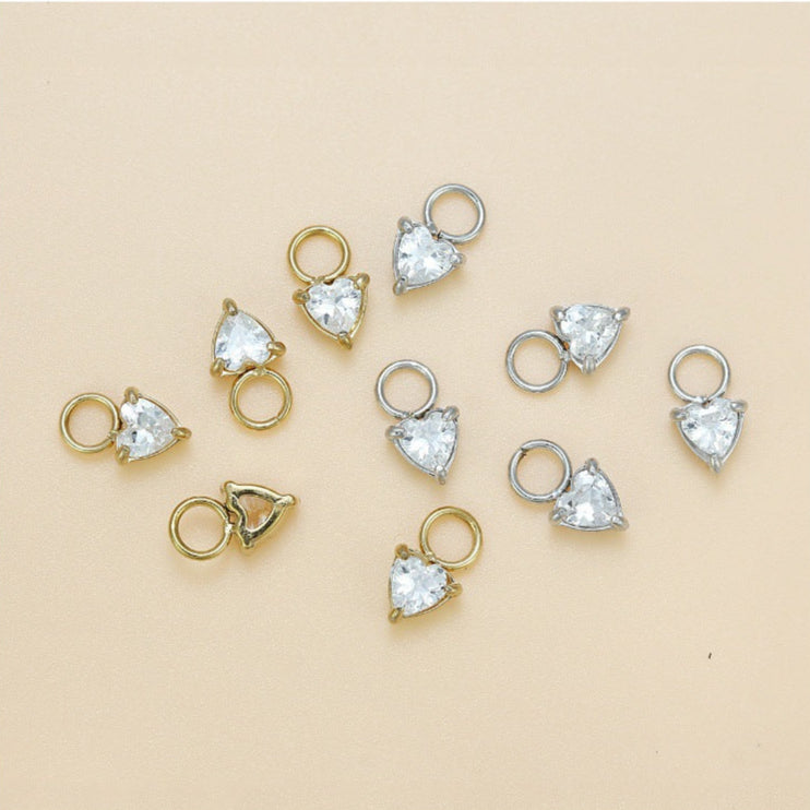 Gold and silver jewelry components with measurements on a beige background