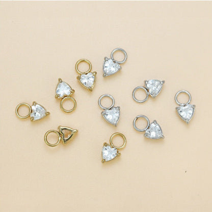 Gold and silver jewelry components with measurements on a beige background