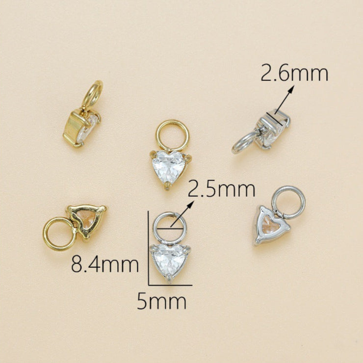 Gold and silver jewelry components with measurements on a beige background