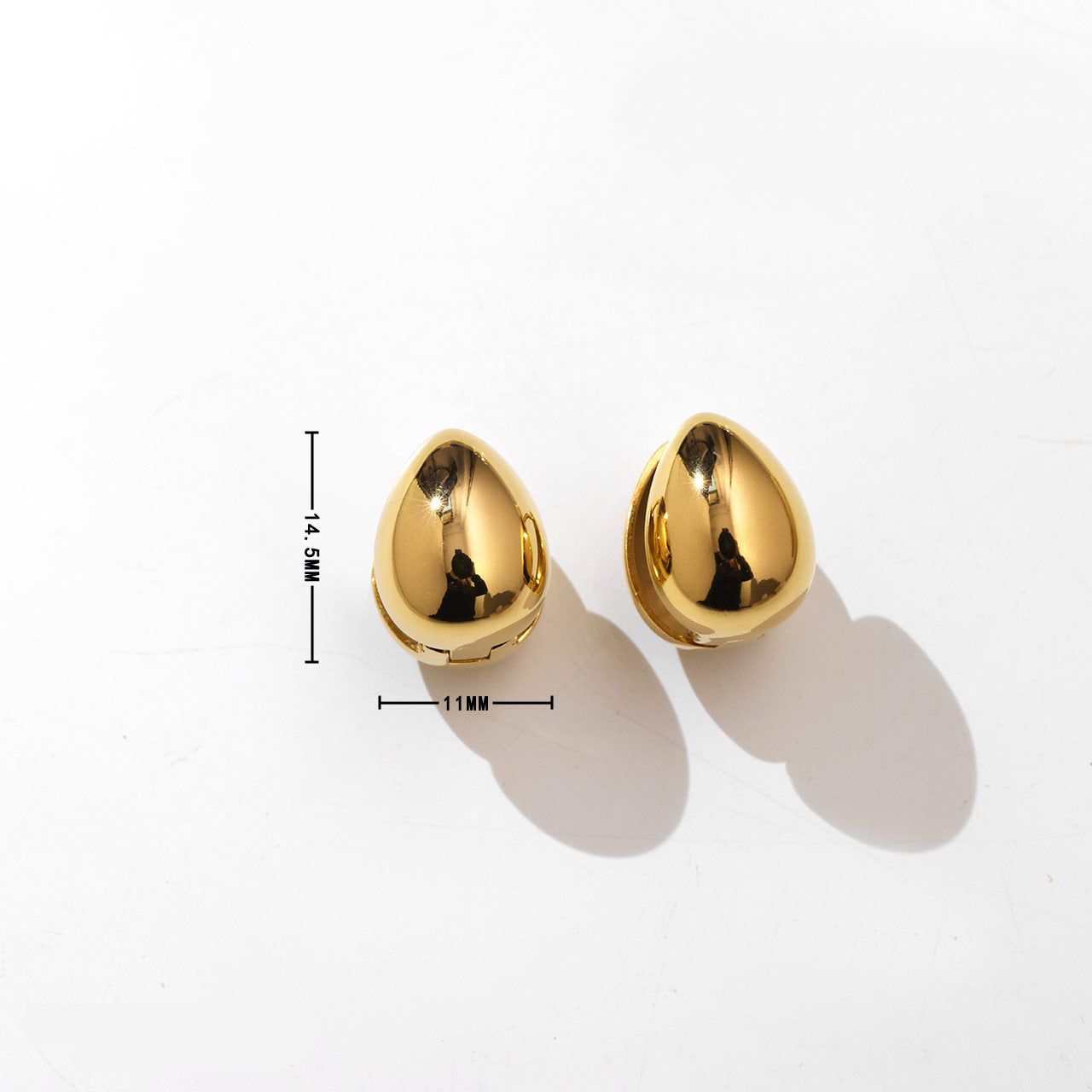Gold earrings on a white background