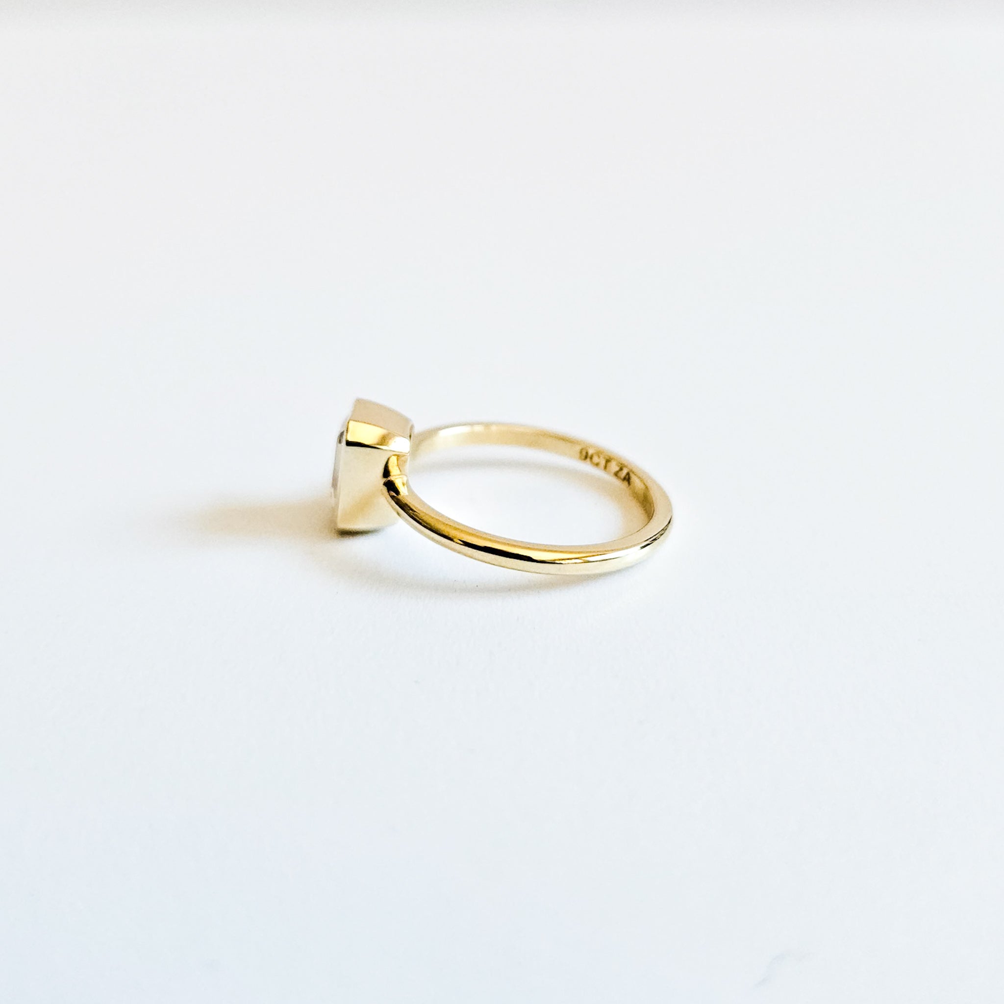 Minimalist Bezel Set Emerald Cut Solitaire Ring