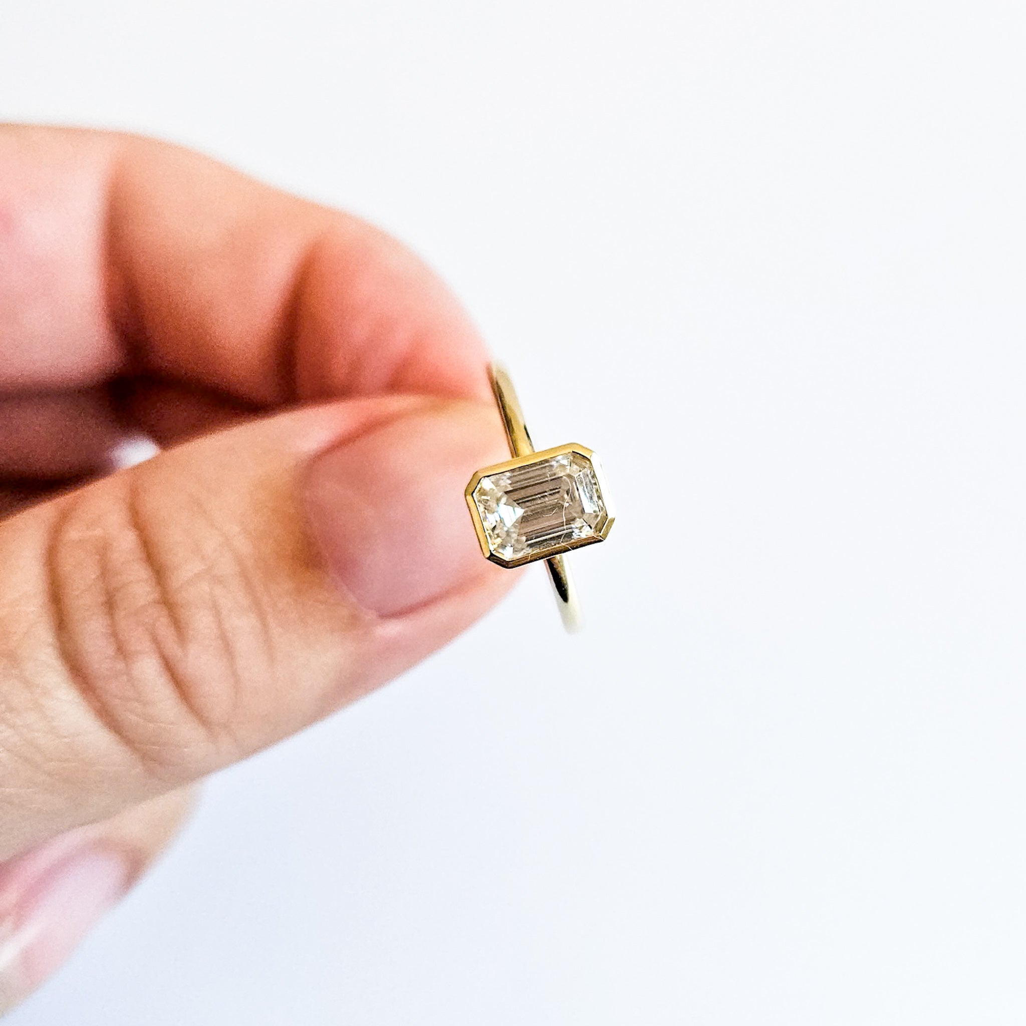 Minimalist Bezel Set Emerald Cut Solitaire Ring