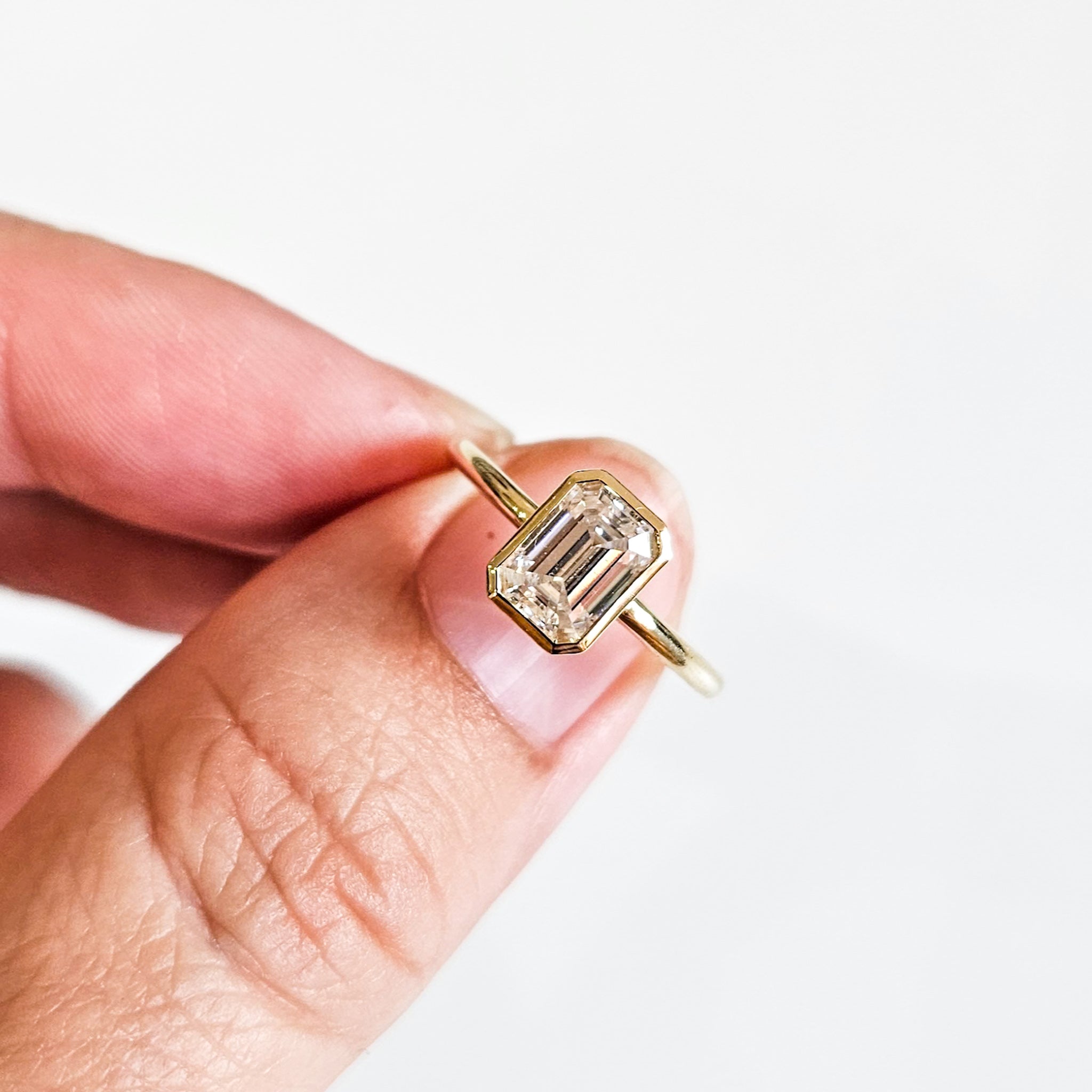 Minimalist Bezel Set Emerald Cut Solitaire Ring