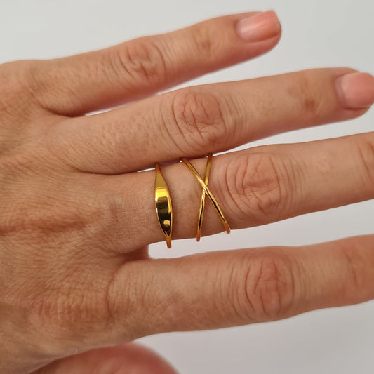 Echo ring in yellow gold styled on hand next to orbit ring as a stacked look