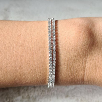 Sterling silver and cubic zirconia tennis choker necklace wrapped twice around wrist and worn as a bracelet