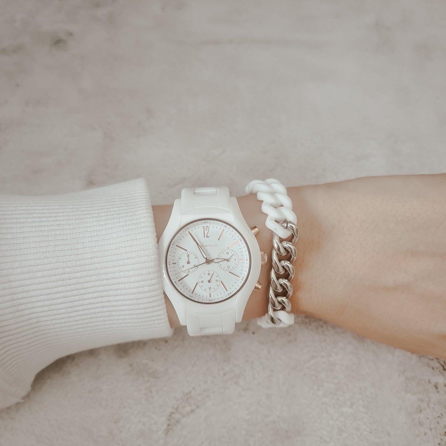 White and silver tone metal and silicone bracelet seen on woman's wrist