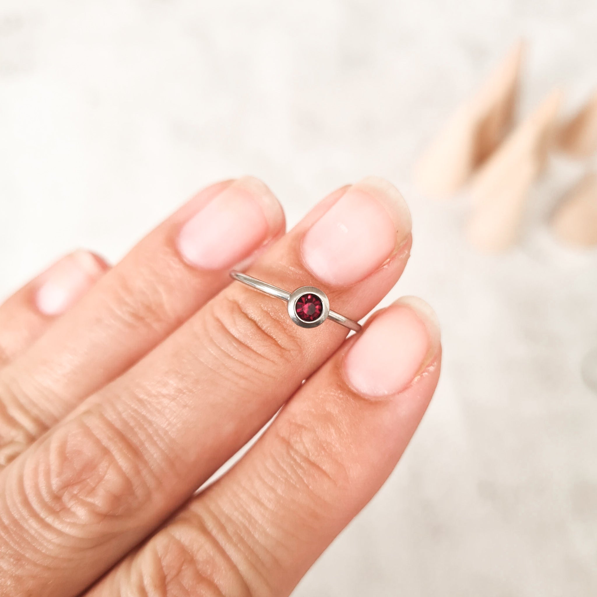 February  cubic zirconia coloured birthstone ring made from stainless steel. The gemstone represents the month you were born in.